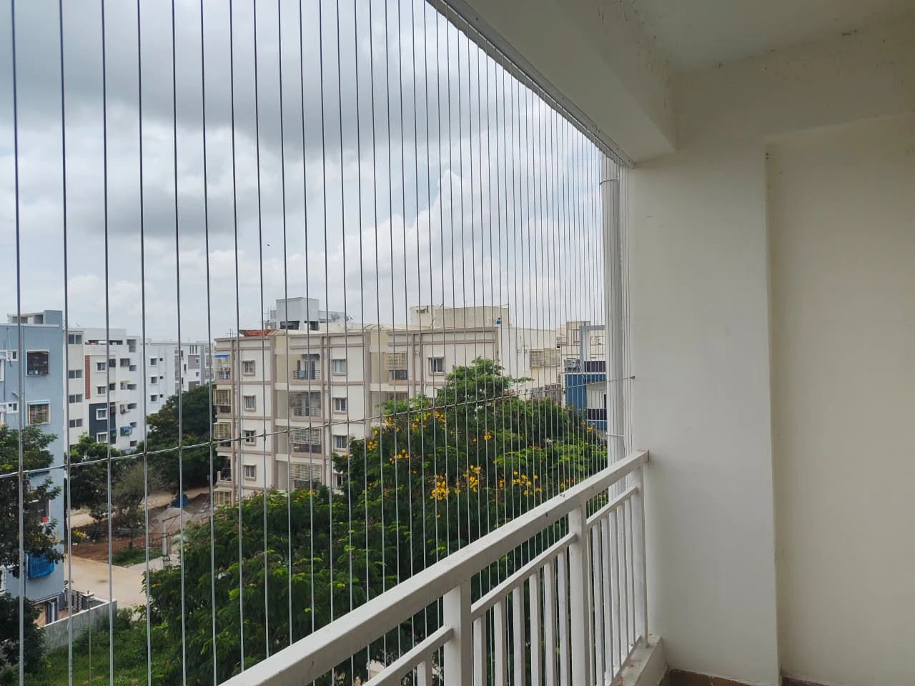 Balcony invisible grills fitted to a high-rise apartment balcony in Hyderabad